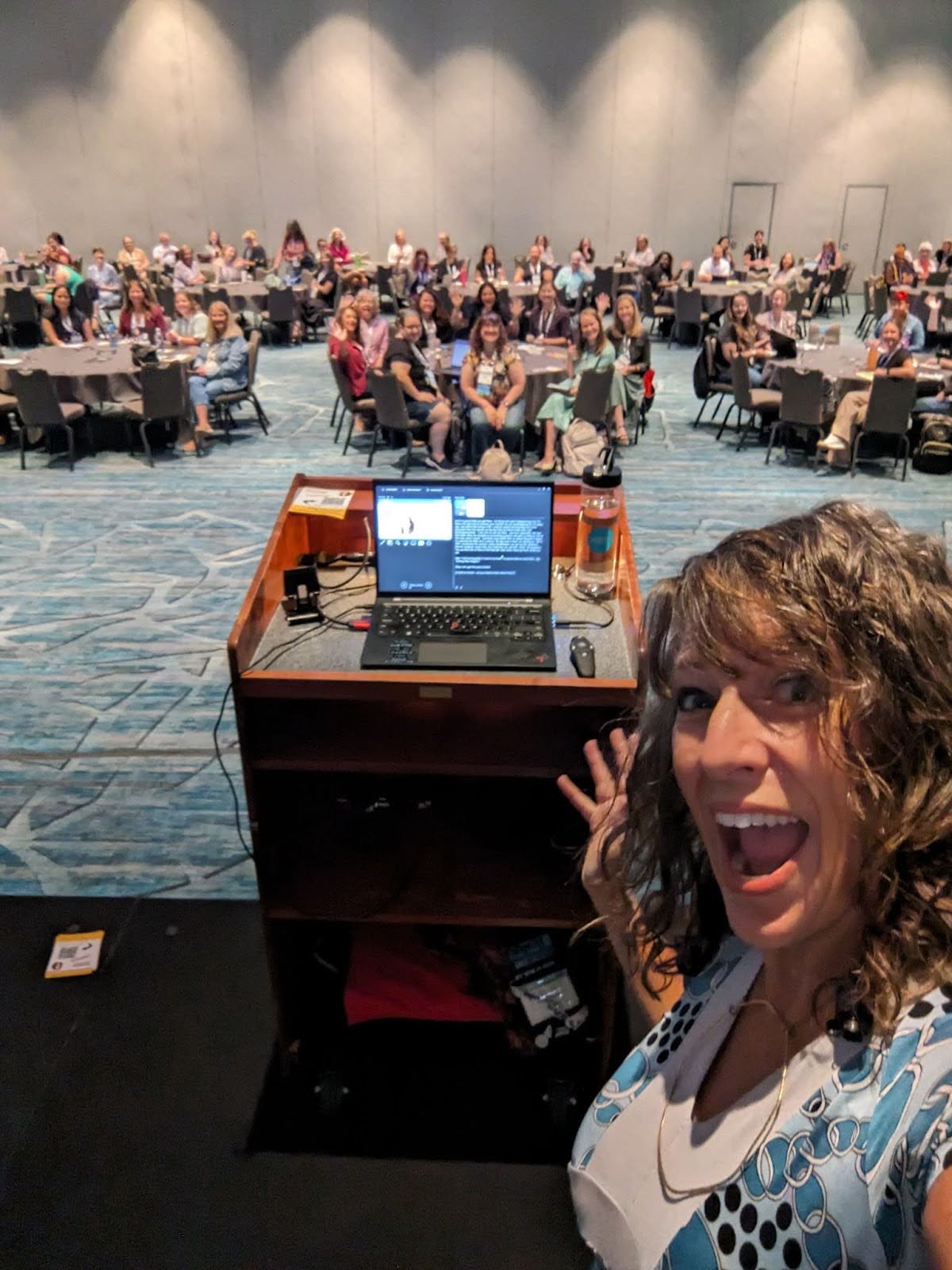 Nancy taking a selfie with attendees at a conference