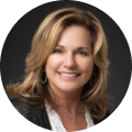 Nancy Wilson Smiling woman with wavy blonde hair wearing a dark jacket and white top, posing in front of a dark background—perfect for illustrating confidence when searching for Jetpack Workflow alternatives.