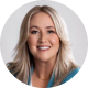 Headshot of a smiling woman with long blonde hair wearing a teal top against a light background.