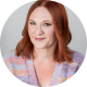 RaeAnn Stout Headshot of a woman with red hair wearing a pastel knit top, smiling slightly at the camera.