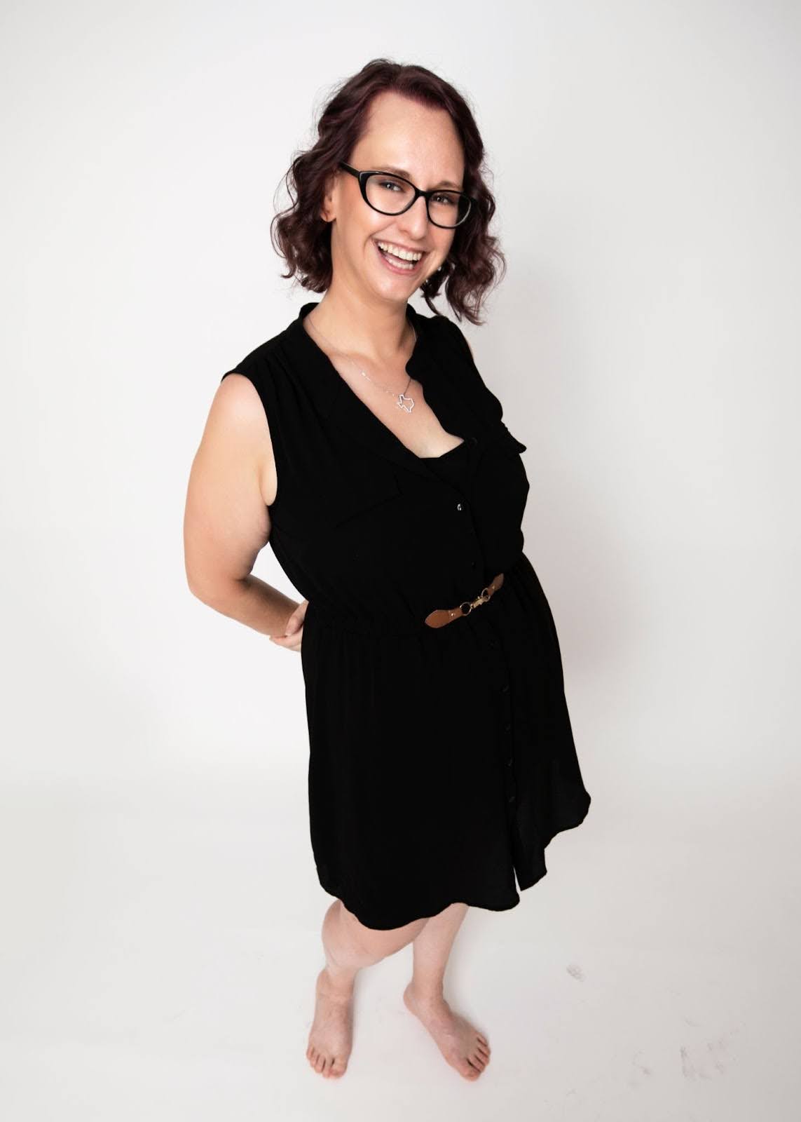A picture of Sarah smiling while standing